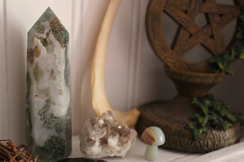 A serene and organized space ready for spellcasting, featuring candles, crystals, and herbs